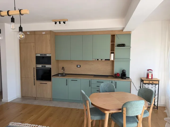 The sage-green kitchen